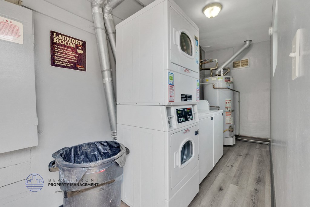 a laundry room with two washing machines and a washer and dryer