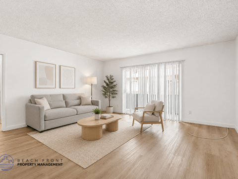 A living room with a grey couch, a wooden coffee table, and a chair.