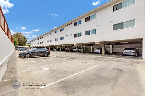 a large parking lot with cars in front of a building