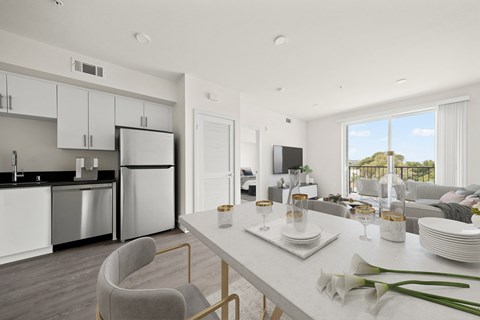 an open kitchen and living room with a table and chairs