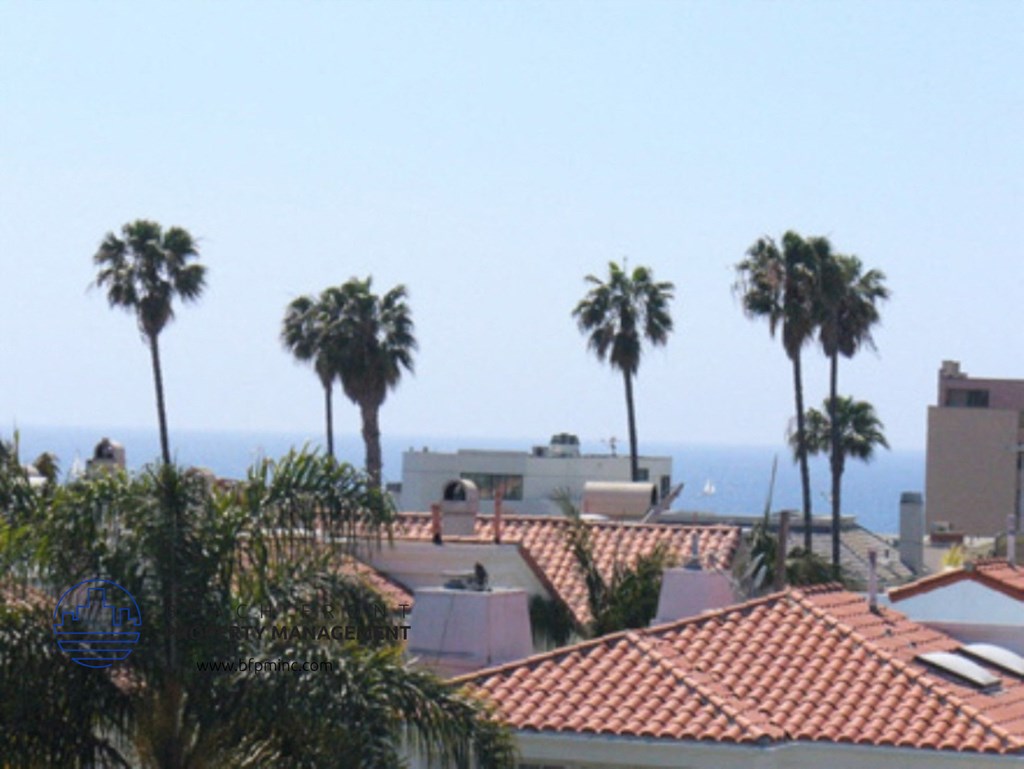 a view of the ocean from the roof of a house