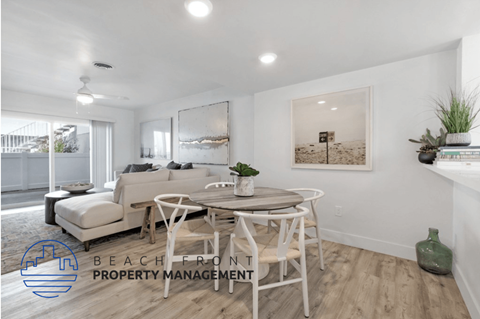 an image of a living room and dining room with a couch and a table