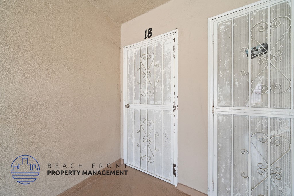 A white door with a glass window is closed.