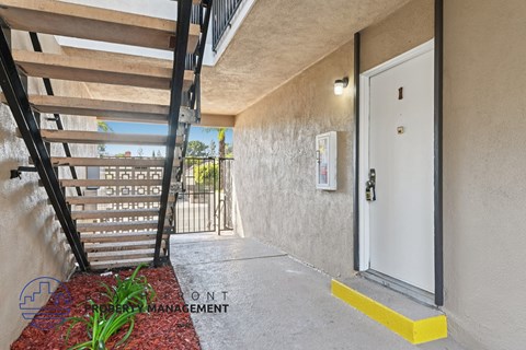 A white door with a yellow step stool is on the right side of the image.