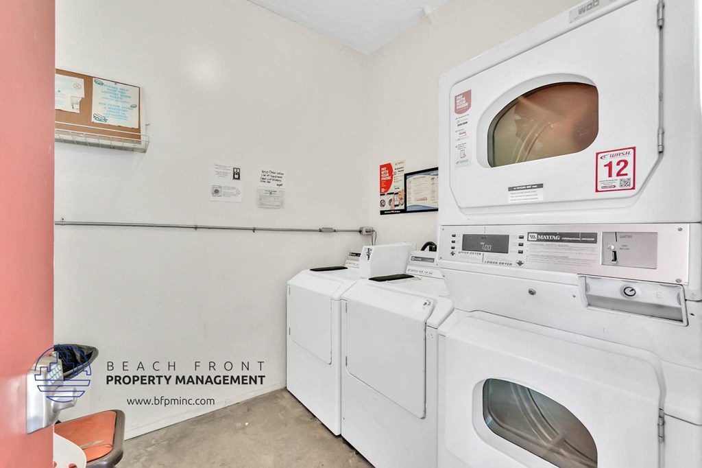 a laundry room with washes and dryers and a microwave