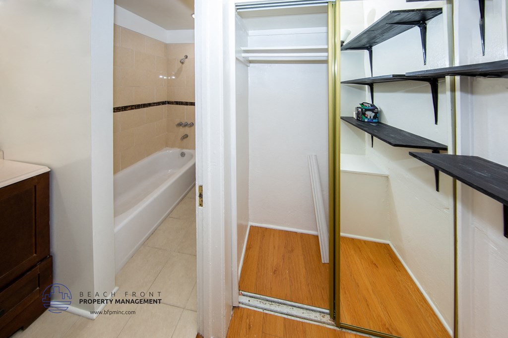 a small bathroom with a shower and a sink and a mirror