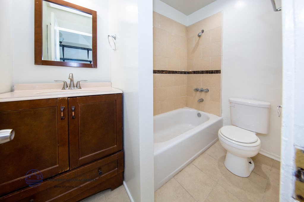 a bathroom with a toilet and a sink and a bath tub