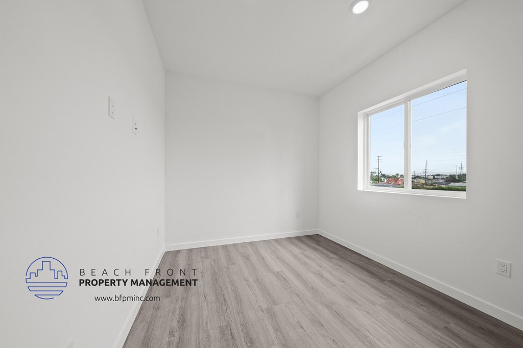 an empty room with white walls and a window