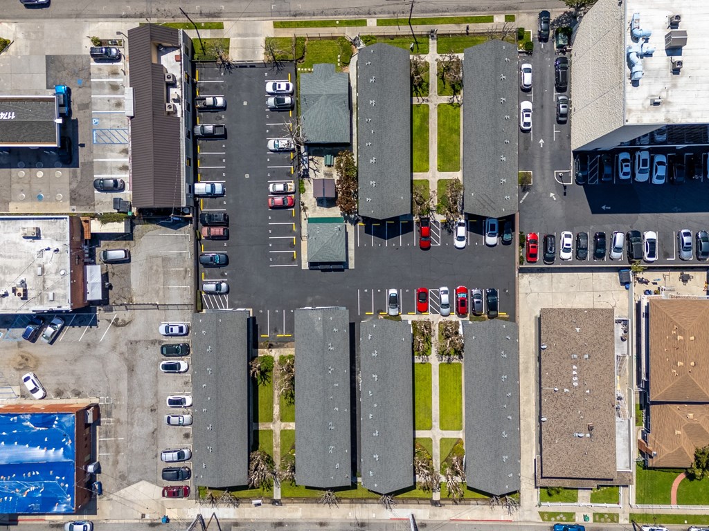 an aerial view of a parking lot with cars parked in it