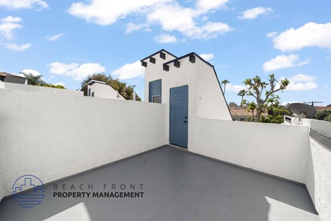 A white building with a blue door is shown with the words "Beach Front Property Management" on the bottom left.