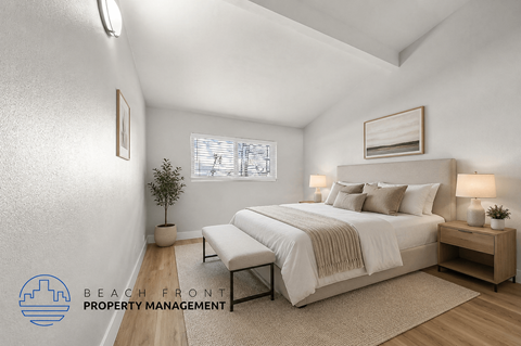 A well-lit bedroom with a large bed and a small plant on the side table.