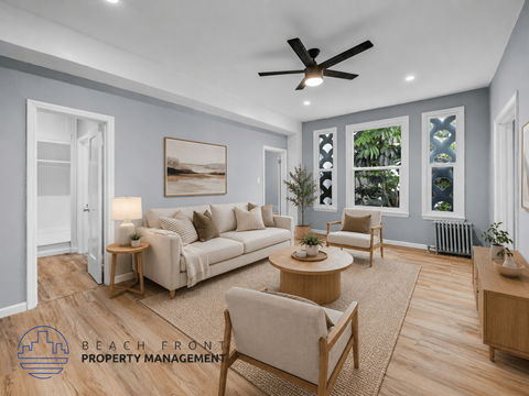 A living room with a couch, chairs, and a ceiling fan.