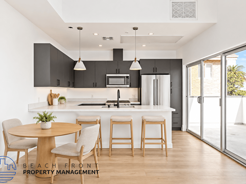 A modern kitchen with a dining table set for four.