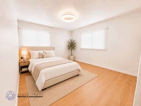A bedroom with a bed, nightstand, and a plant.