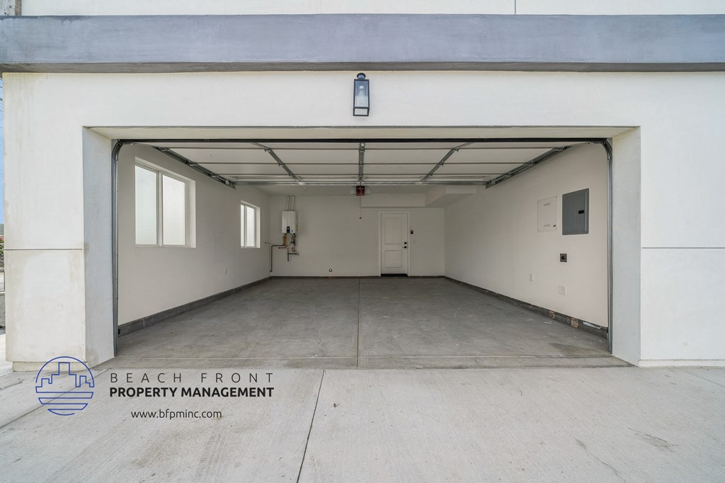 the inside of a garage with a white wall and a concrete floor