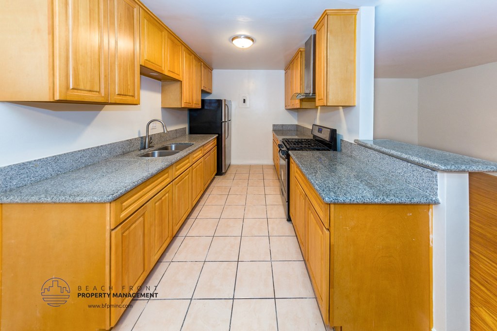 full kitchen with wood cabinets and granite counter tops and black appliances