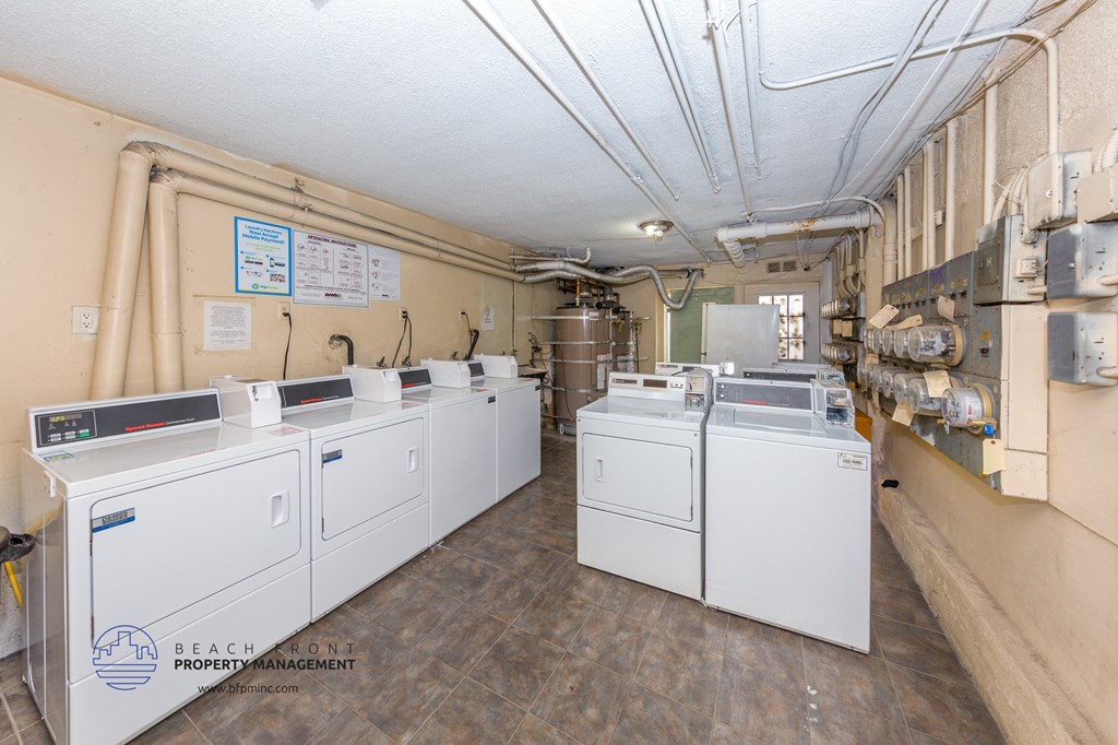 the laundry room is equipped with four washes and dryers