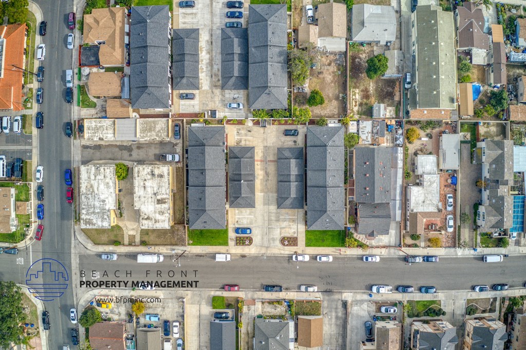 a birds eye view of a neighborhood with cars parked on the street and houses