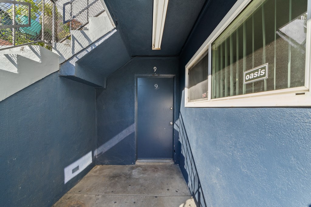 the entrance to a blue building with a blue door