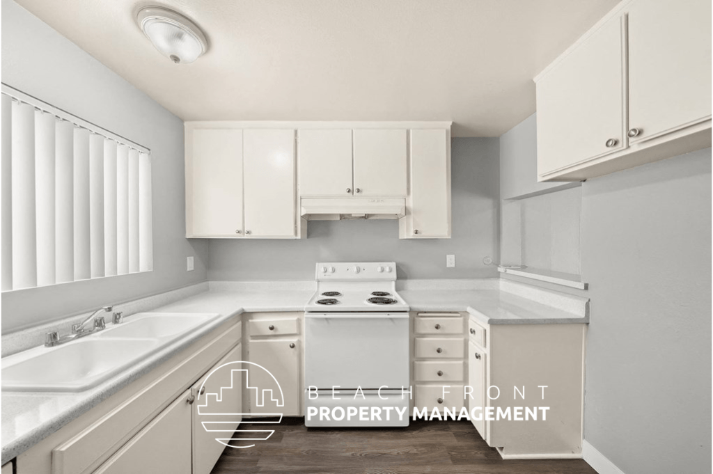 a white kitchen with white cabinets and white appliances and a sink