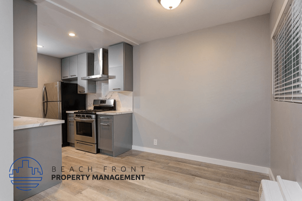 a kitchen with an island and a stove and a refrigerator
