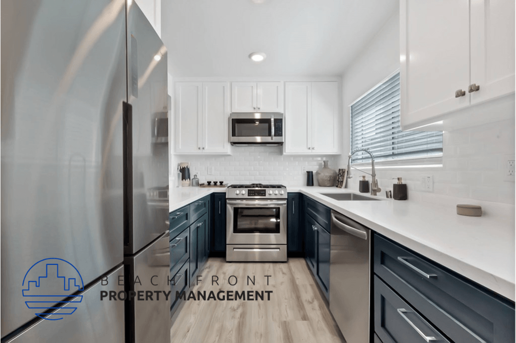 a kitchen with blue and white cabinets and stainless steel appliances