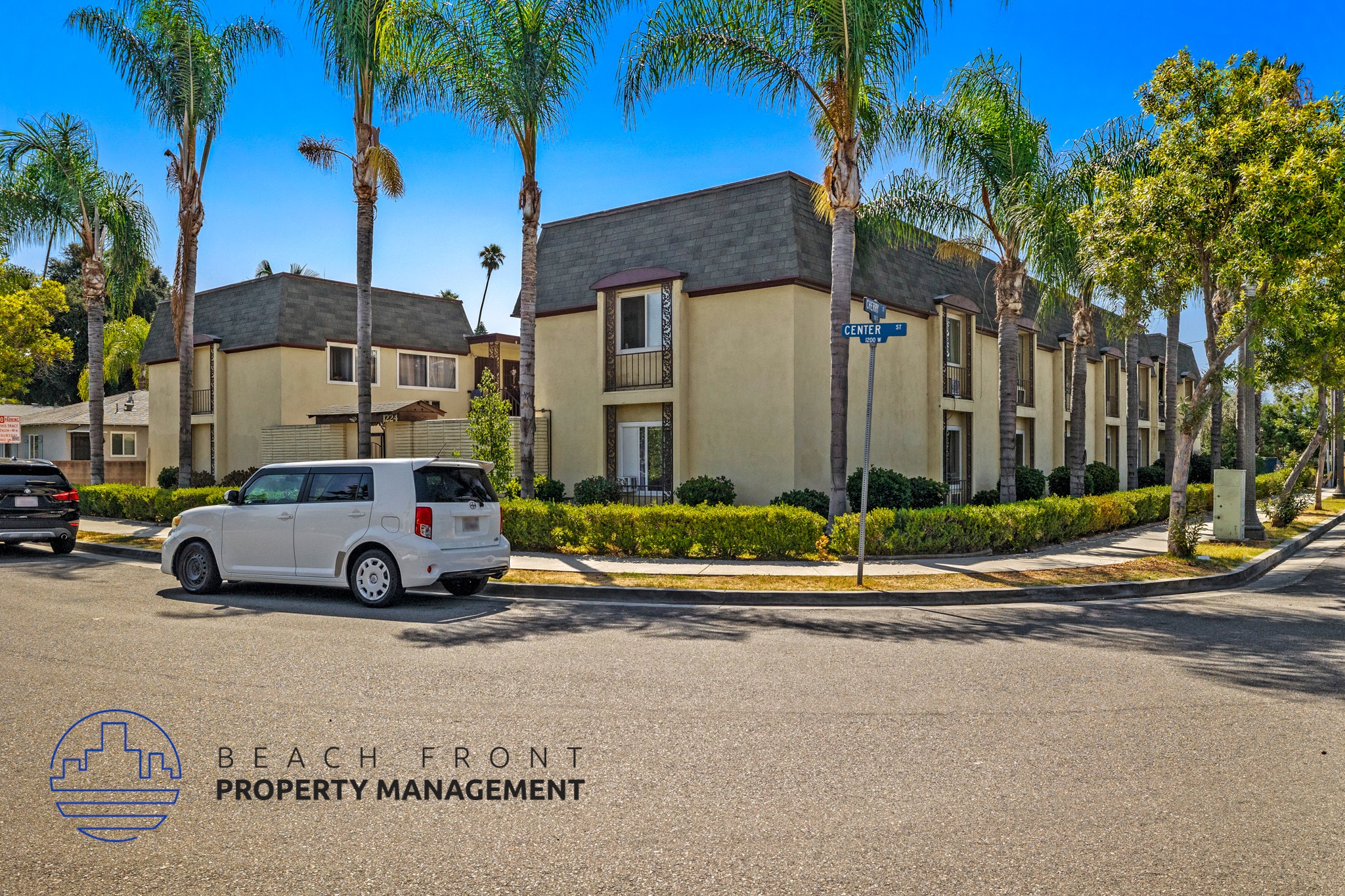 a van parked in front of a building with palm trees