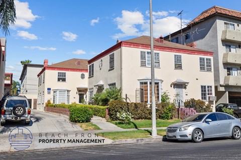 an image of a house with a car parked in front of it