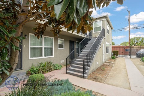 A house with a staircase leading to the front door.