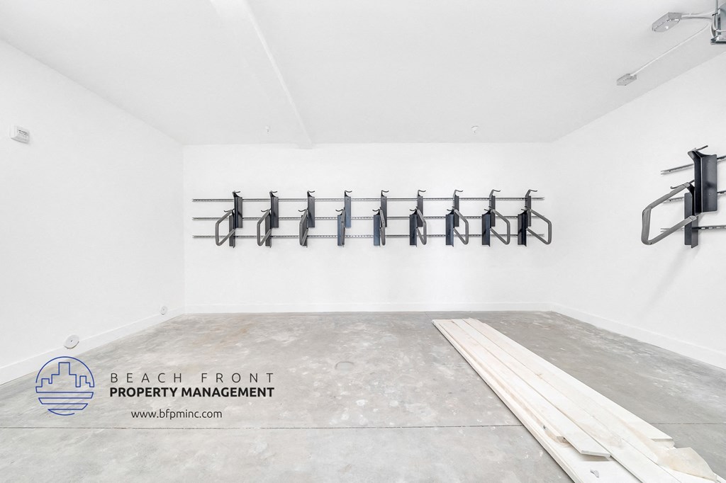an empty room with a row of hangers on the wall