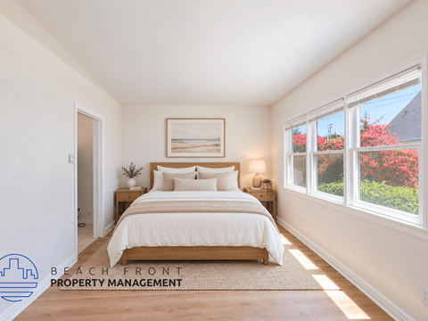 A bedroom with a large bed and a window overlooking a garden.