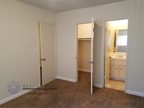a bathroom with two doors and a sink and a mirror