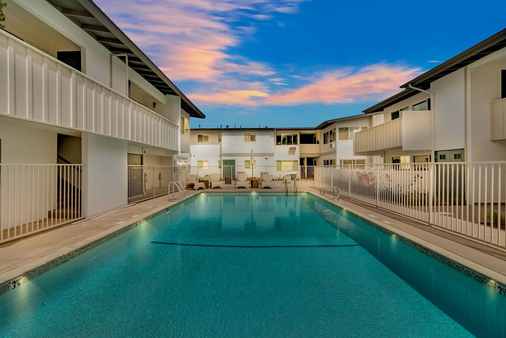 A swimming pool in a residential area surrounded by buildings.