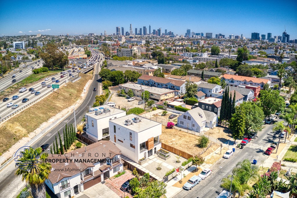 an aerial view of a development with a city in the background