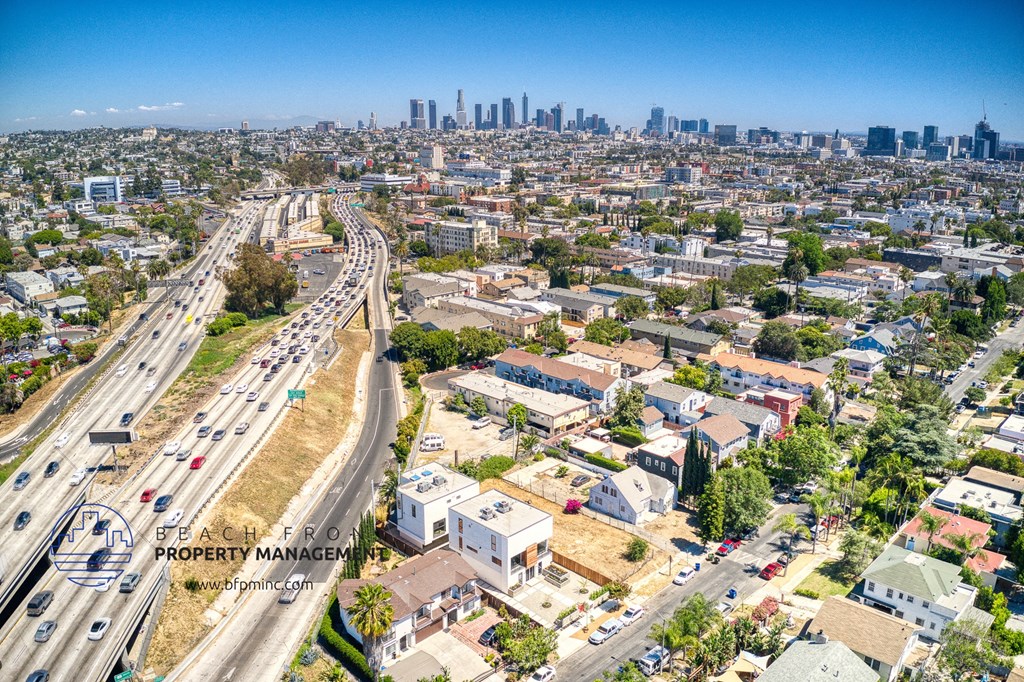 an aerial view of the city with highways and buildings