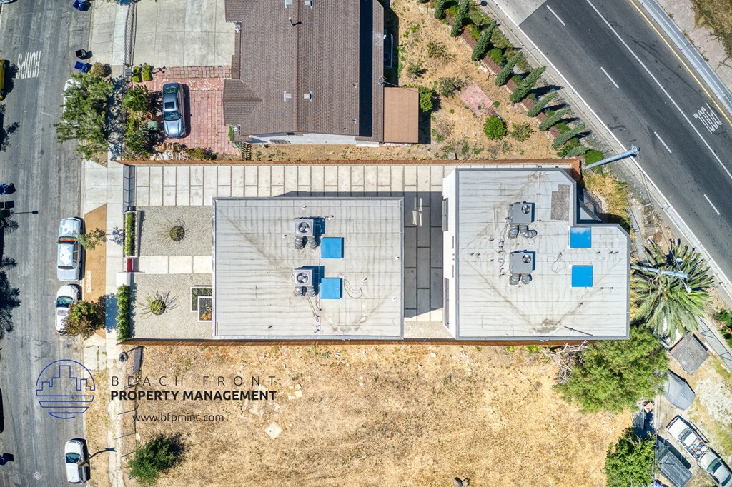 a birds eye view of a building with a roof and a parking lot