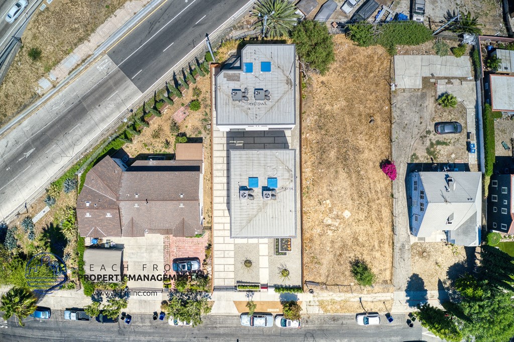 an overhead view of a building with a yard and a street