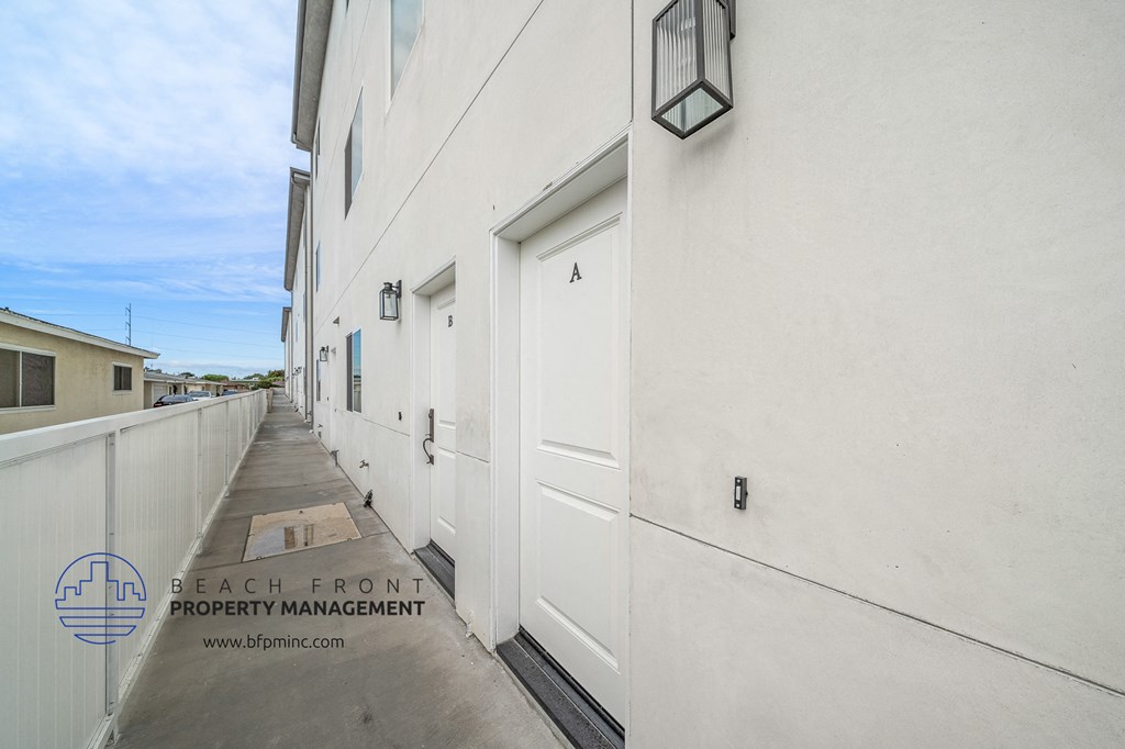 a view of the side of a building with white doors