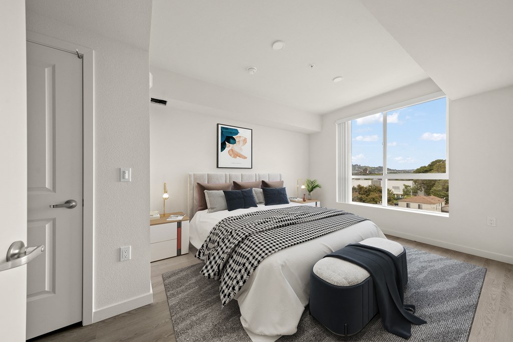 a bedroom with a large bed and a large window