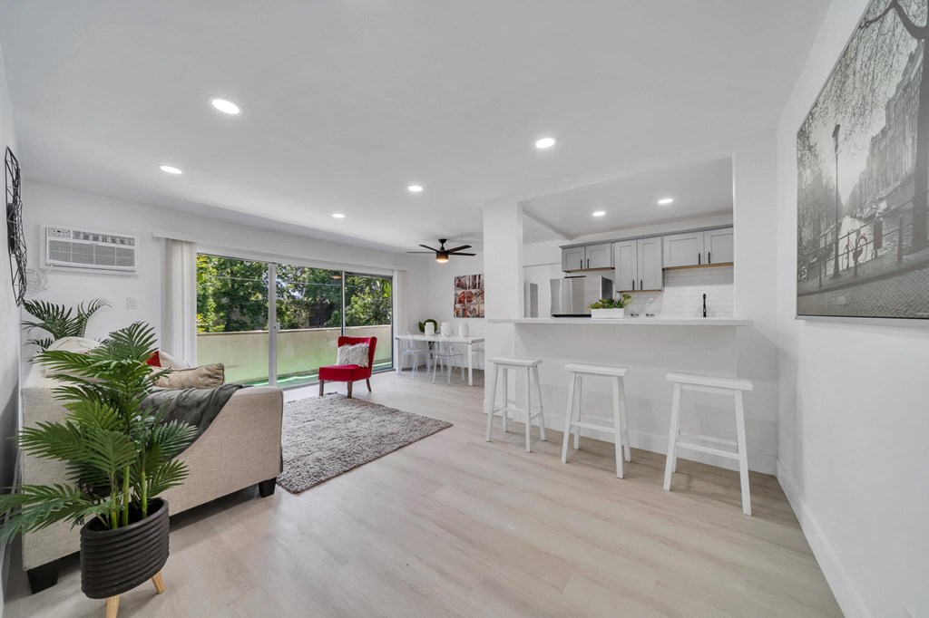 a living room with a couch and a bar and a kitchen