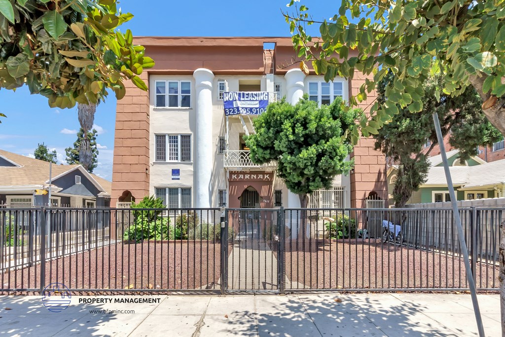 a building with a fence and a gate in front of it