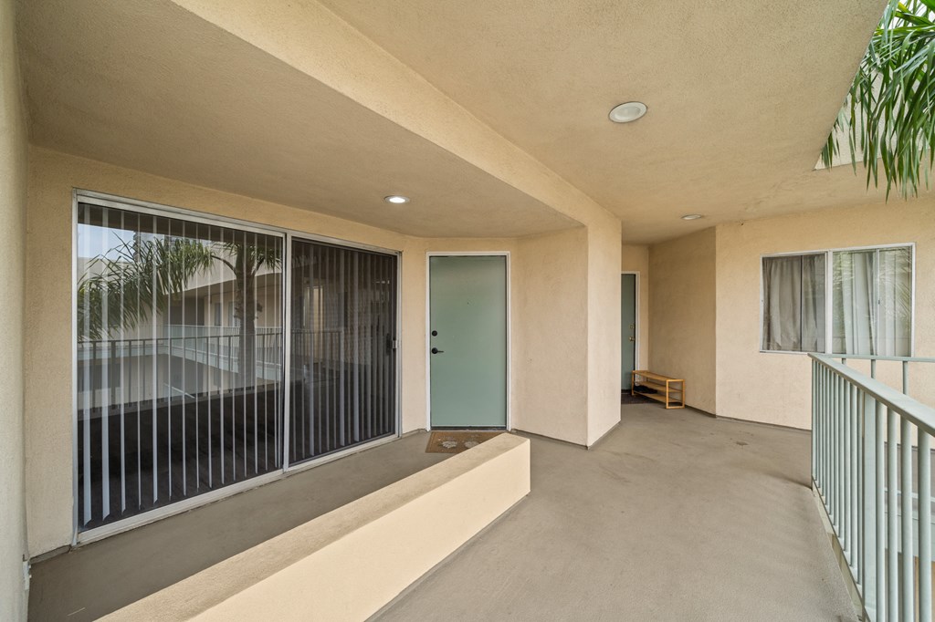 a hallway with a large window and a door to a room