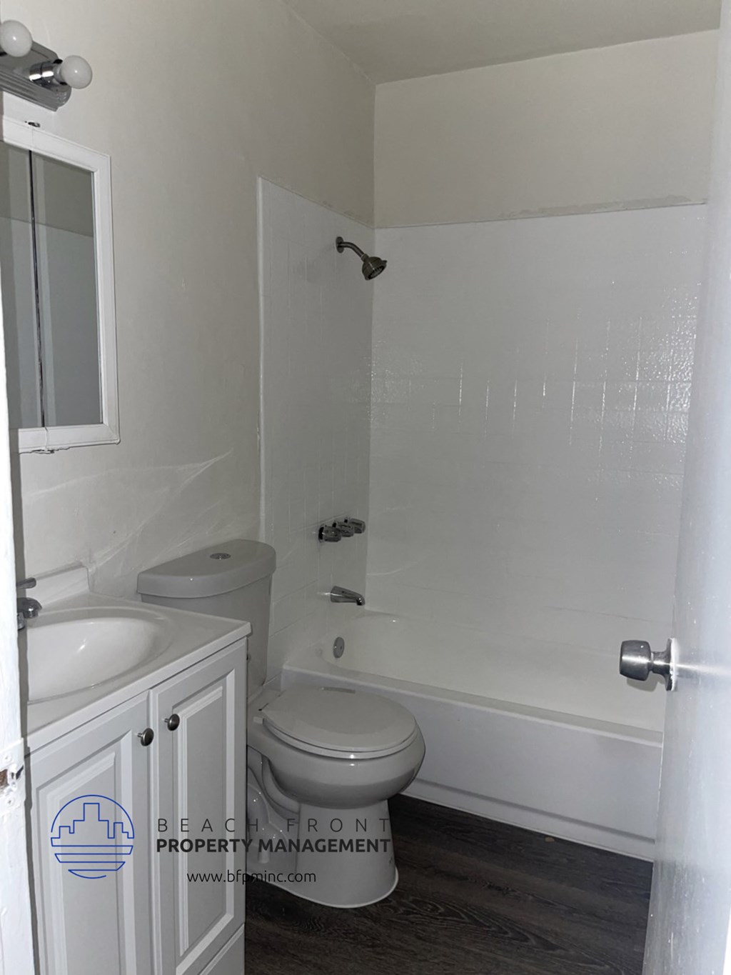 a small bathroom with a toilet and a tub and a sink