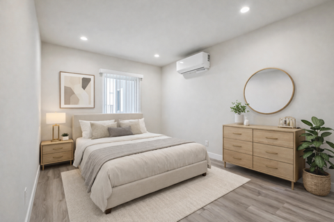 A bedroom with a large bed, a nightstand, and a dresser.