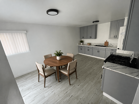 A kitchen with a table and chairs in the middle of the room.