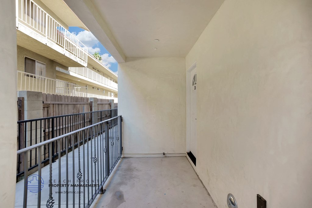 the balcony of a building with a gate and a fence