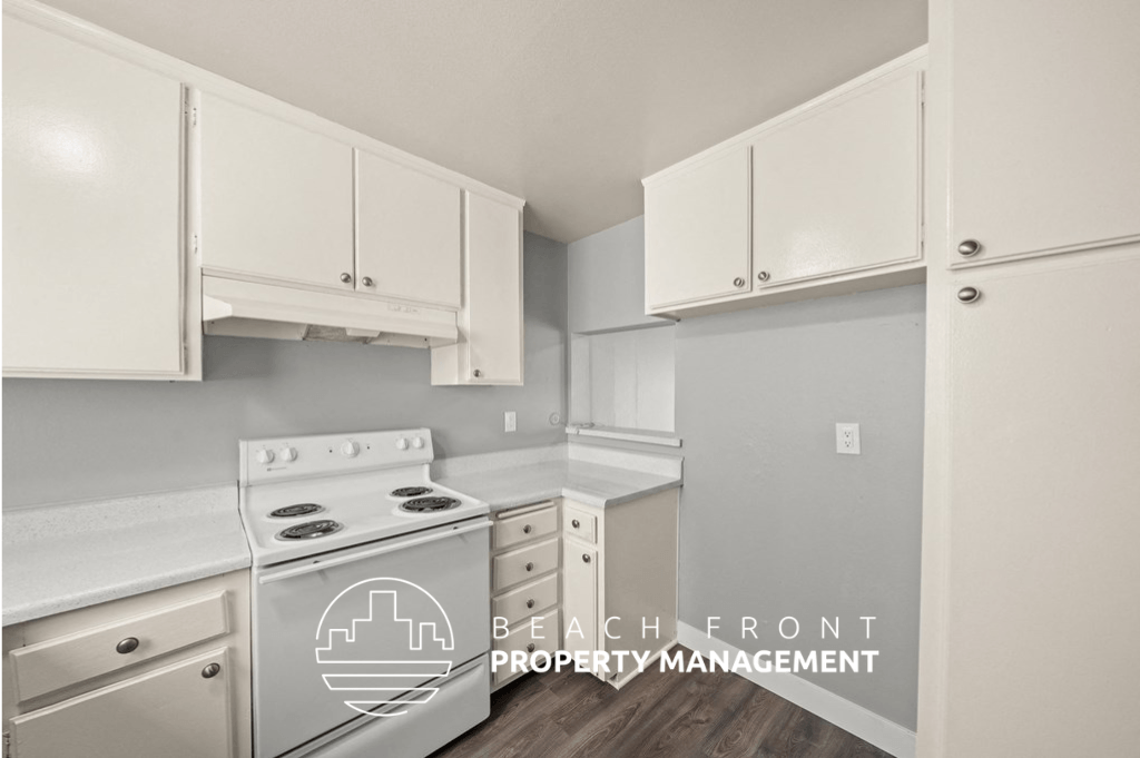 a white kitchen with white cabinets and white appliances
