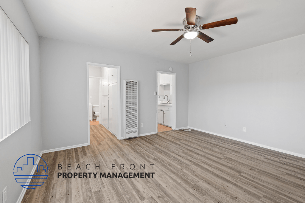 a living room with wood flooring and a ceiling fan