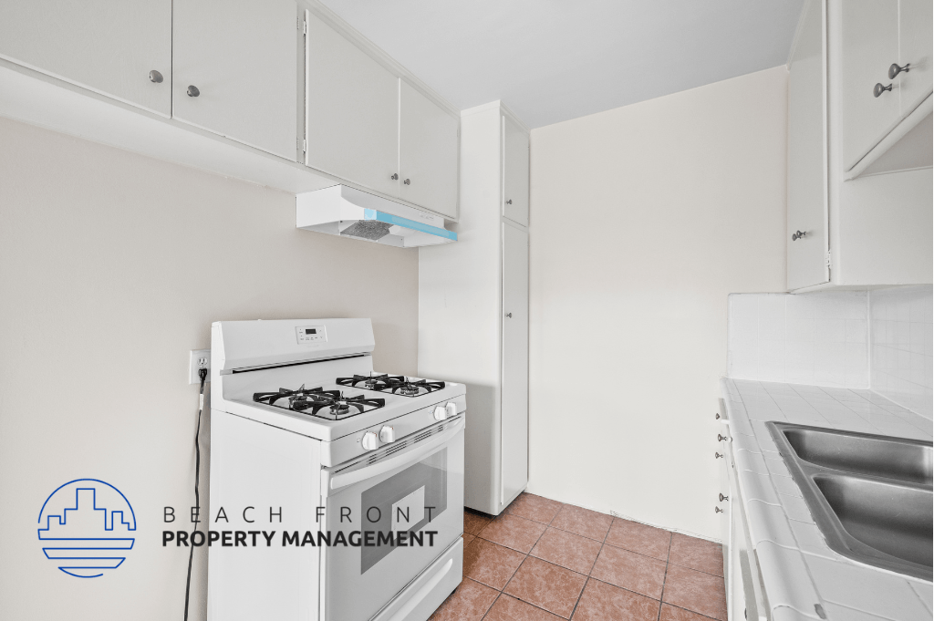 a kitchen with a stove and a sink and a refrigerator