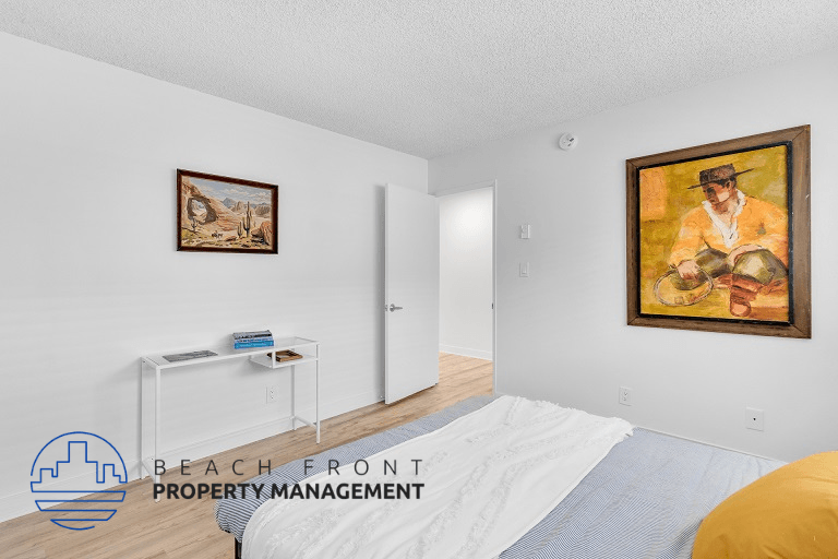 a bedroom with a bed and a painting on the wall